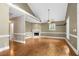 Spacious living room with hardwood floors, fireplace, and large windows offering ample natural light at 4594 Poplar Rd, Pine Lake, GA 30072