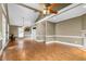 Spacious living room with hardwood floors, ceiling fans, and large windows providing ample natural light at 4594 Poplar Rd, Pine Lake, GA 30072