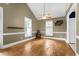 Spacious living room with hardwood floors and large windows providing ample natural light at 4594 Poplar Rd, Pine Lake, GA 30072
