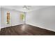 Bedroom with hardwood floors, neutral walls, and natural light from windows and door at 7025 Bavarian Wood Pl, Buford, GA 30518
