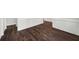 Close-up of dark hardwood flooring with elegant trim details and a clean aesthetic at 7025 Bavarian Wood Pl, Buford, GA 30518