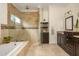 Bathroom featuring tiled shower and tub, dark wood cabinetry, and granite countertops at 177 Ridgeland Ave, Decatur, GA 30030