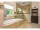 Bathroom featuring tiled shower and tub and granite countertops at 177 Ridgeland Ave, Decatur, GA 30030