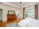 Well-lit main bedroom featuring hard wood floors, a large window, and outdoor access at 177 Ridgeland Ave, Decatur, GA 30030