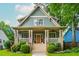 Charming home featuring a welcoming front porch with a manicured lawn and beautiful landscaping at 177 Ridgeland Ave, Decatur, GA 30030