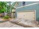 A two car garage with a concrete driveway is visible behind a wooden fence and mature landscaping at 177 Ridgeland Ave, Decatur, GA 30030