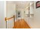 Bright hallway with hardwood floors, built-in shelving, and a view of a room at the end of the hall at 177 Ridgeland Ave, Decatur, GA 30030