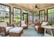 Bright sunroom with wicker seating, perfect for enjoying natural light and views of the outdoor scenery at 177 Ridgeland Ave, Decatur, GA 30030