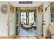 Sunlit sunroom with wicker furniture, creating a peaceful retreat with views of the surrounding landscape at 177 Ridgeland Ave, Decatur, GA 30030