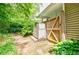 Enclosed backyard with a wooden fence, outdoor changing room, and mature landscaping at 3027 Vista Brook Dr, Decatur, GA 30033