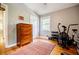 Bright bedroom featuring hardwood floors, dresser and fitness equipment near a sunny window at 3027 Vista Brook Dr, Decatur, GA 30033