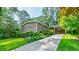 Charming exterior view with a long driveway, well-manicured lawn, and lush landscaping at 3027 Vista Brook Dr, Decatur, GA 30033