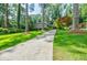 Exterior shot showcases a home with a long driveway surrounded by a lush green lawn at 3027 Vista Brook Dr, Decatur, GA 30033