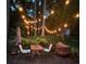 Charming patio with string lights, table, chairs, and lush greenery makes for a delightful outdoor retreat at 3027 Vista Brook Dr, Decatur, GA 30033