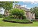 Landscaped backyard featuring lush greenery and mature trees, offering a private and serene outdoor space at 3099 Hidden Falls Dr, Buford, GA 30519