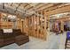 Unfinished basement with exposed beams, a small sofa, and ample space for storage or customization at 3099 Hidden Falls Dr, Buford, GA 30519