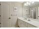Neutral bathroom features a white vanity with a marble countertop, a mirror, and decorative wall art at 3099 Hidden Falls Dr, Buford, GA 30519