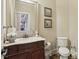 Powder room featuring a wood vanity and a commode at 3099 Hidden Falls Dr, Buford, GA 30519