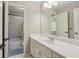 Bright bathroom with a white vanity, tile floors, and an attached shower at 3099 Hidden Falls Dr, Buford, GA 30519