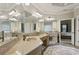 A bathroom featuring a dual vanity, ample lighting, and an open doorway to a bedroom at 3099 Hidden Falls Dr, Buford, GA 30519