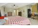 Bright bedroom features a ceiling fan, carpeting, several dressers, a bed and an office area at 3099 Hidden Falls Dr, Buford, GA 30519