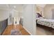 Hallway with hardwood floors leading to a bedroom with a decorative wall art at 3099 Hidden Falls Dr, Buford, GA 30519