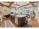 Spacious island kitchen with stainless appliances, modern lighting, open floor plan, and hardwood floors at 3099 Hidden Falls Dr, Buford, GA 30519