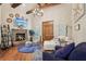 Inviting living room with hardwood floors, stone fireplace, wooden beamed ceiling, and cozy seating at 3099 Hidden Falls Dr, Buford, GA 30519