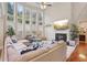 Bright and airy living room featuring floor-to-ceiling windows, a fireplace, and comfortable seating at 3099 Hidden Falls Dr, Buford, GA 30519