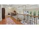 Loft area with hardwood floors and a view overlooking the living room at 3099 Hidden Falls Dr, Buford, GA 30519