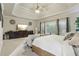 Bright main bedroom boasting tray ceilings, a ceiling fan, and large windows at 3099 Hidden Falls Dr, Buford, GA 30519