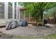 Covered patio with ample seating overlooks a stone paver patio and manicured grounds at 3099 Hidden Falls Dr, Buford, GA 30519