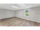 Finished basement with wood-look flooring and a window offers extra space and natural light at 5254 Greenpoint Drive, Stone Mountain, GA 30088