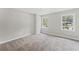 Spacious bedroom with carpet, modern lighting, and lots of natural light at 5254 Greenpoint Drive, Stone Mountain, GA 30088