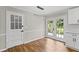 Bright dining area featuring stylish hardwood flooring and doors leading to the backyard at 5254 Greenpoint Drive, Stone Mountain, GA 30088