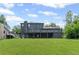 Backyard home view featuring a deck overlooking the expansive yard and a walkout basement at 5254 Greenpoint Drive, Stone Mountain, GA 30088
