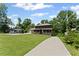 Charming two-story home with a welcoming front porch and lush green lawn at 5254 Greenpoint Drive, Stone Mountain, GA 30088