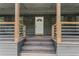 Inviting front porch with wooden columns, steps and railing at 5254 Greenpoint Drive, Stone Mountain, GA 30088