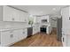 Modern kitchen with white cabinets, stainless steel appliances, and wood floors at 5254 Greenpoint Drive, Stone Mountain, GA 30088