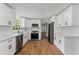 Bright, newly renovated kitchen with white cabinets, tiled backsplash, and modern appliances at 5254 Greenpoint Drive, Stone Mountain, GA 30088