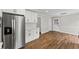 Bright kitchen featuring stainless steel refrigerator, white cabinetry, and hardwood floors at 5254 Greenpoint Drive, Stone Mountain, GA 30088