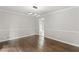 Spacious living room featuring hardwood floors, modern lighting, and crown molding details at 5254 Greenpoint Drive, Stone Mountain, GA 30088