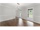 Bright living room boasts hardwood floors, modern lighting, and large windows overlooking the front yard at 5254 Greenpoint Drive, Stone Mountain, GA 30088