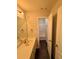 Bright bathroom featuring a single sink vanity and a shower-tub combination at 5688 Baffin Rd, Atlanta, GA 30349