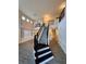 Stunning two-story foyer featuring a staircase with black iron railings and wood flooring at 5688 Baffin Rd, Atlanta, GA 30349