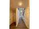 Hallway featuring hardwood floors, with a view to the front door, staircase, and hallway at 5688 Baffin Rd, Atlanta, GA 30349