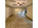 Spacious living room with large windows, carpet flooring, and decorative ceiling fan at 5688 Baffin Rd, Atlanta, GA 30349