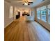 Open-concept living room featuring hardwood floors, ample natural light, and a view into the kitchen at 5688 Baffin Rd, Atlanta, GA 30349