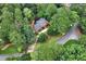 Overhead shot of a home showcasing the roof, driveway, surrounding trees and landscaping in a lush setting at 1320 Northcliff Trce, Roswell, GA 30076