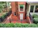Brick basement entrance surrounded by manicured hedges and a black metal fence at 1320 Northcliff Trce, Roswell, GA 30076
